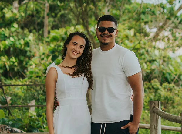 A man and woman smile warmly at the camera