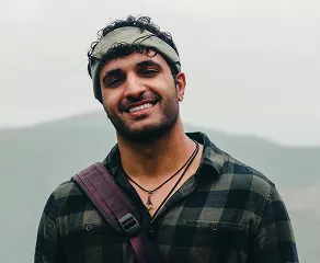A smiling man with glasses and a beard